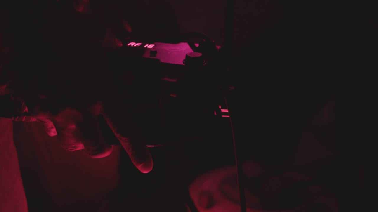 DJ's Hands Recording Audio In The Club With Colorful Glowing Lights - close up