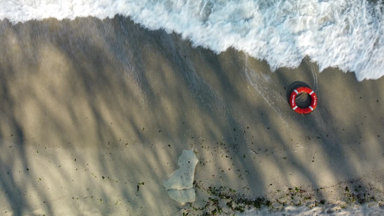 Top view of lifebuoy in the sea shore. Life ring floating in a sea.