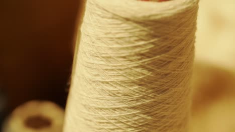 close-up shot of thread unrolled from reel