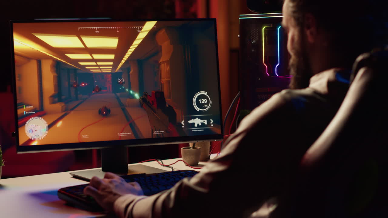 Man in dark living room playing engaging video games on gaming PC at computer desk