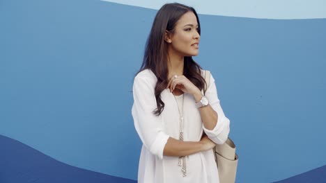 Glamorous-Young-Woman-Standing-At-The-Wall