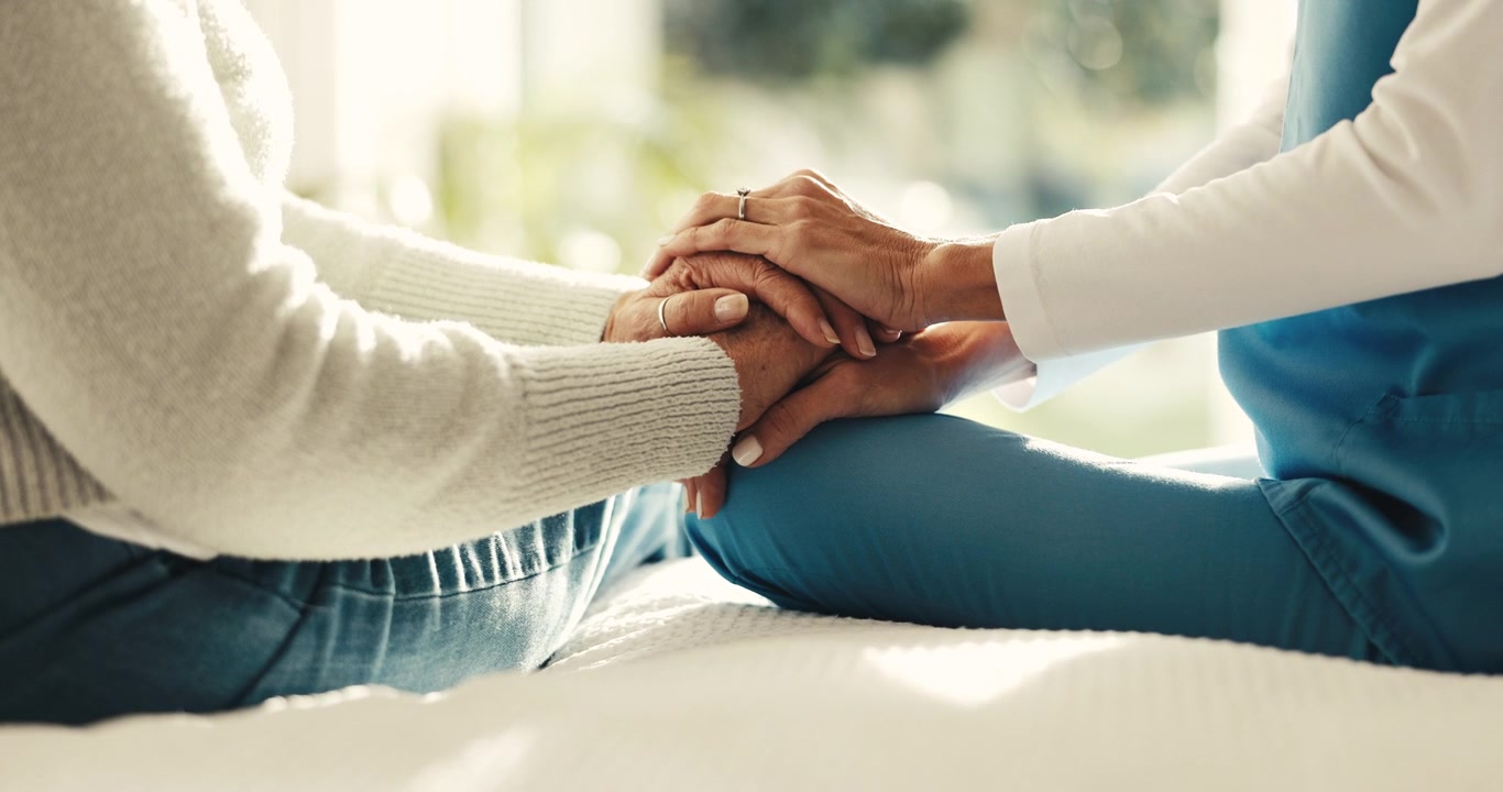 Caregiver Holding Hands of Elderly Patient for Comfort