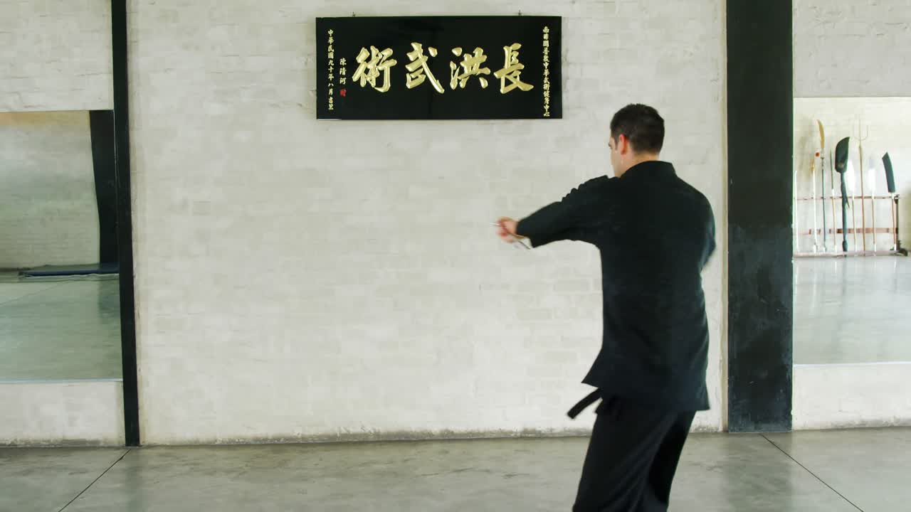 Kung fu fighter practicing martial arts with sword 4k
