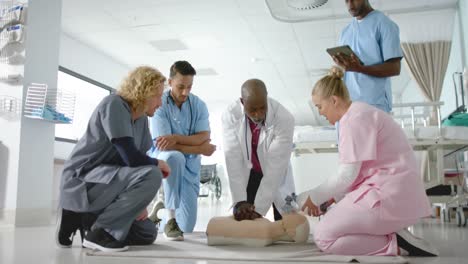 african american doctor training trainee doctors in emergency cpr procedure using dummy, slow motion