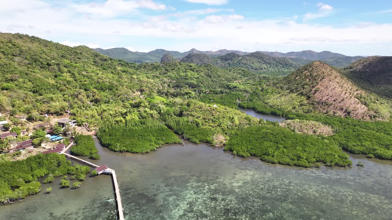Jetty Near Rural Village With Lush Forest Mountain In The Background In Busuanga Island, Philippines. Aerial Drone Shot