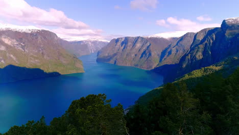 Majestic-blue-fjord-Aurland-in-Norway-on-sunny-day,-aerial-dolly-backwards