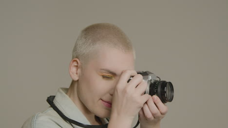 close up shot of model using retro slr camera