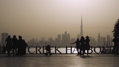 People-Looking-At-Dubai-Skyline-From-Dubai-Creek-Harbour-At-Sunset-In-Dubai,-UAE