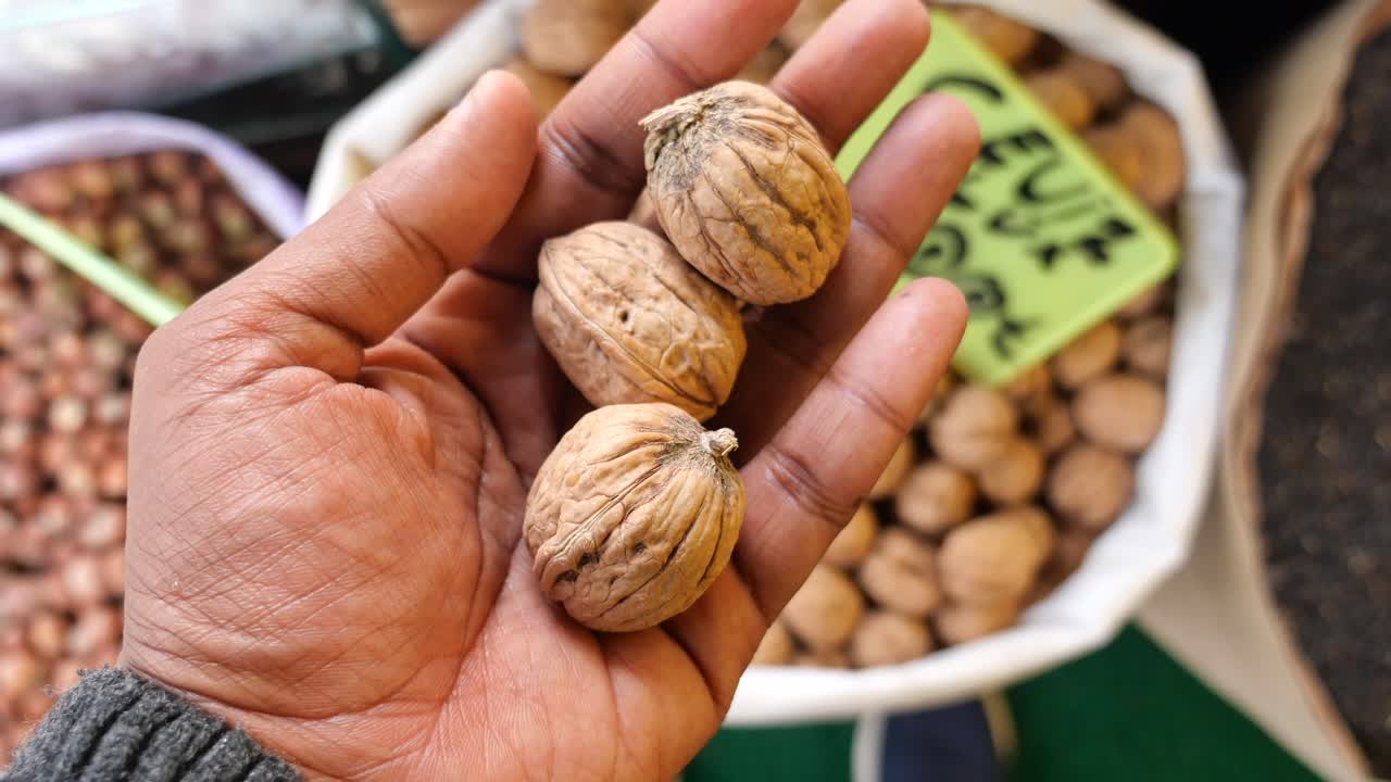 Handful of Walnuts at a Market