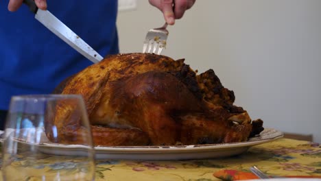 slow motion cutting into thanksgiving turkey - side view