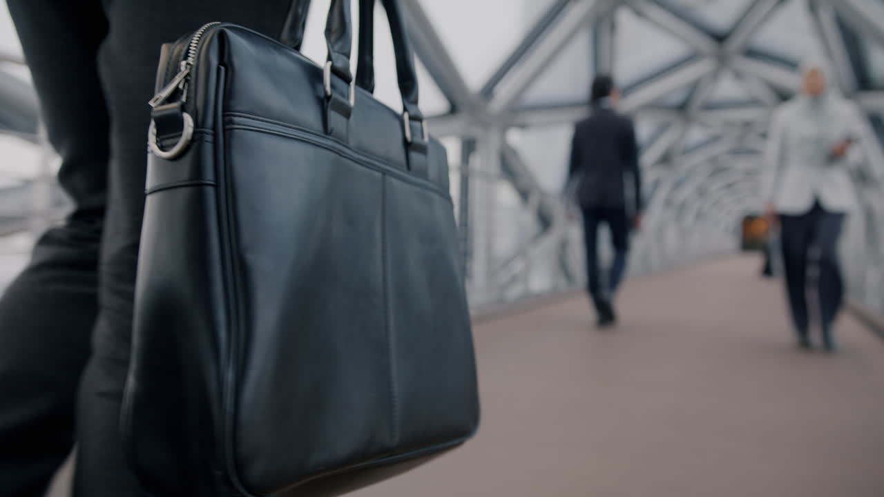 Businessman with briefcase on city bridge
