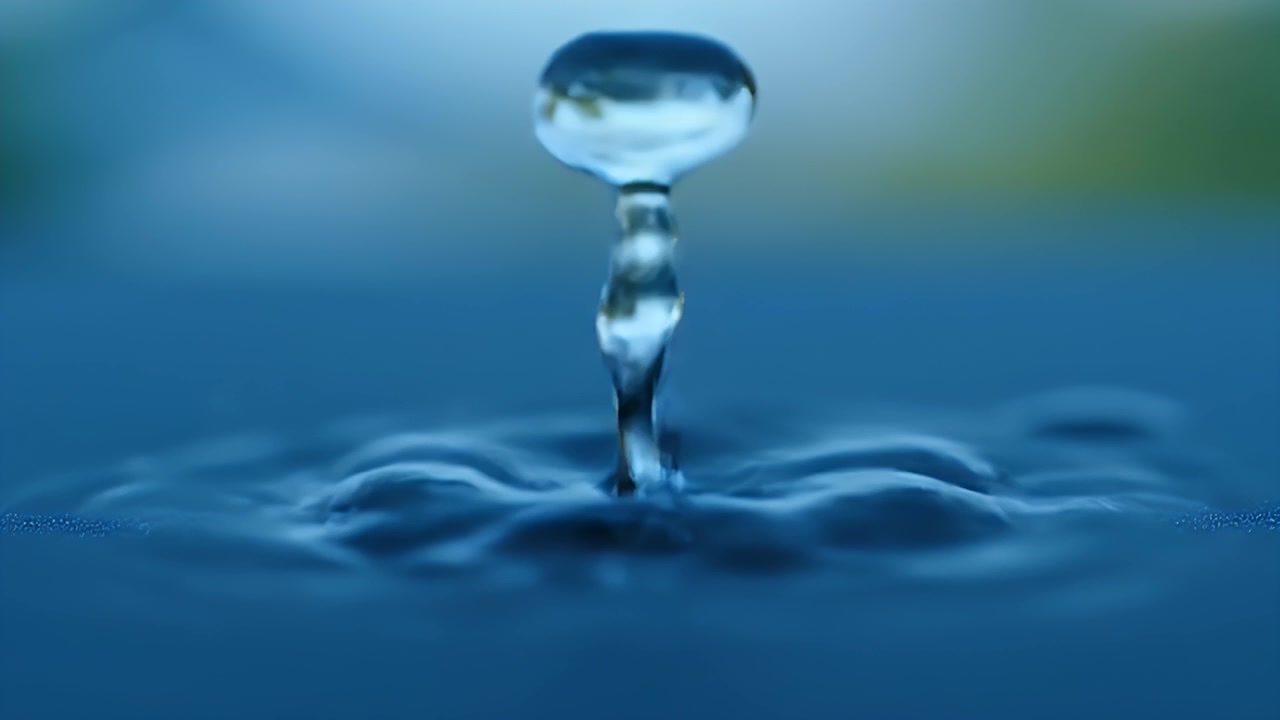 Macro Shot of Water Drop Falling and Creating Ripples