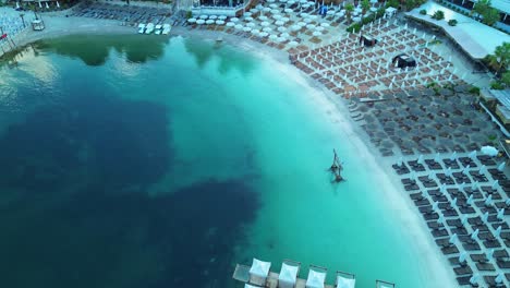 aerial view of a beautiful turquoise beach with umbrellas and sunbeds