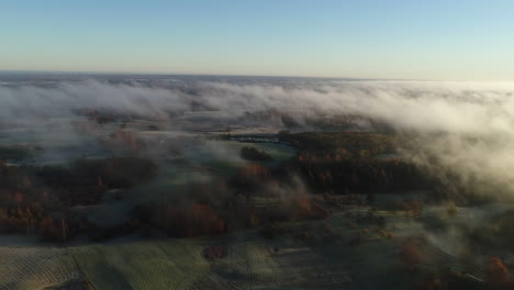 aerial forward over countryside in foggy day