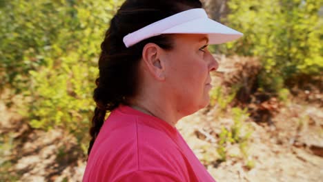 Determined-woman-looking-at-net-during-obstacle-course