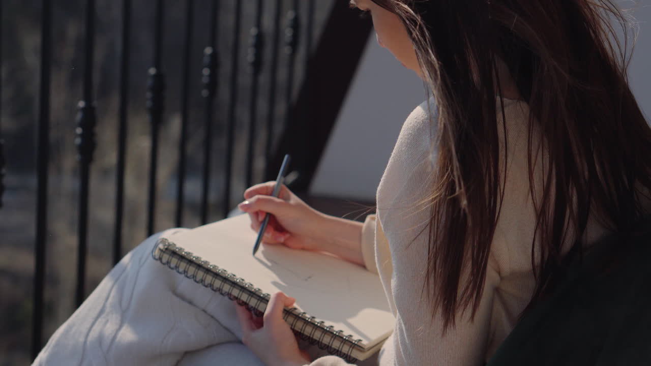 Woman Drawing on a Balcony