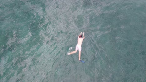 boy snorkeling in beautiful water in hawaii