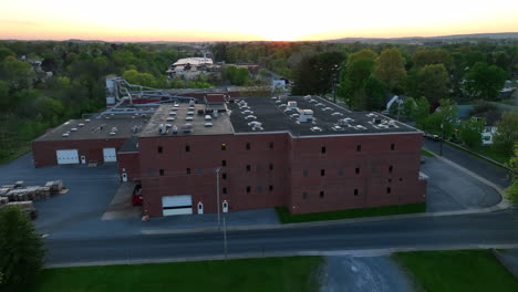 Aerial-shot-of-factory-at-sunset