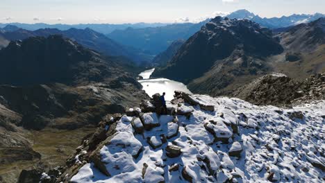 aerial drone top down cview over hiker on top of mountain crest in valmalenco, italy