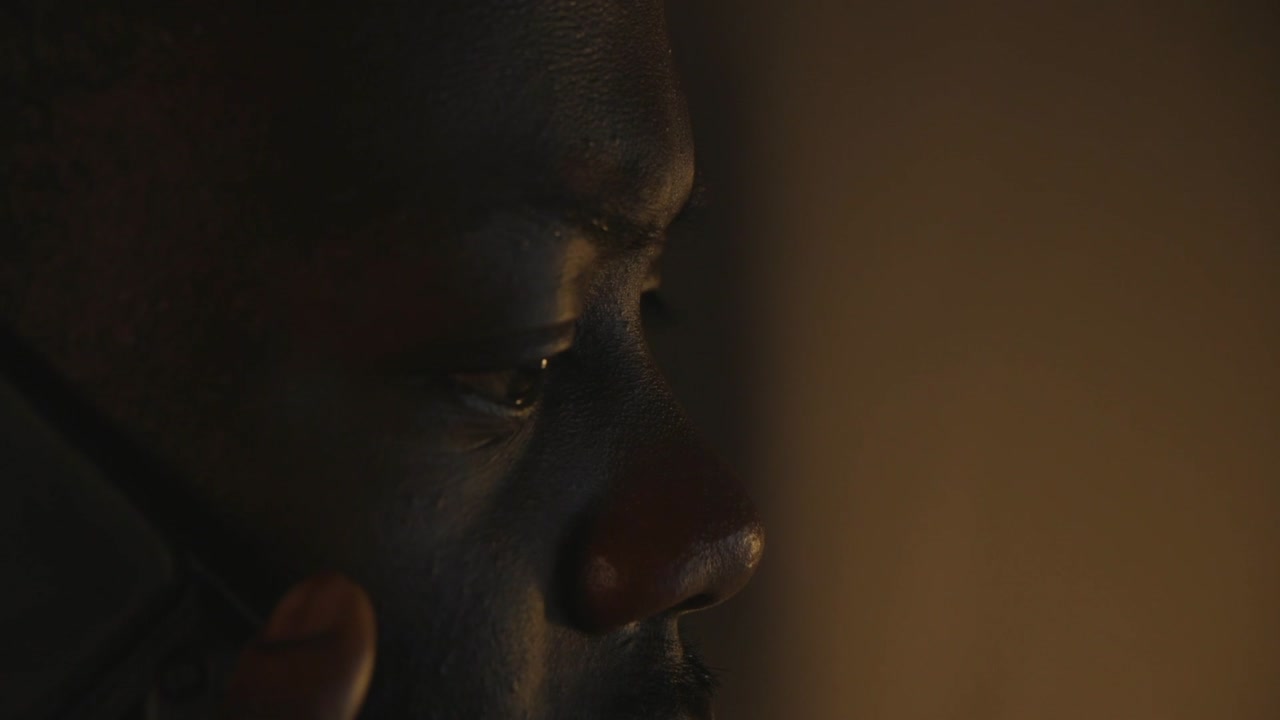 Close Up Of Black Male Picking Up Phone In Dark Home Office