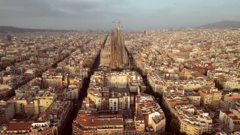 a cinematic aerial drone shot of the entire catalonia featuring la sagrada familia cathedral