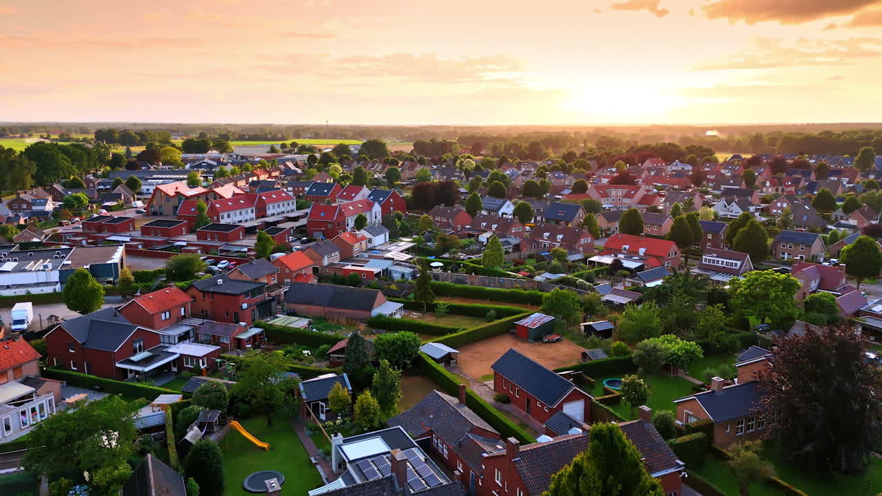 Cozy residential area with lush greenery. Drone footage over the town in the Netherlands at sunset