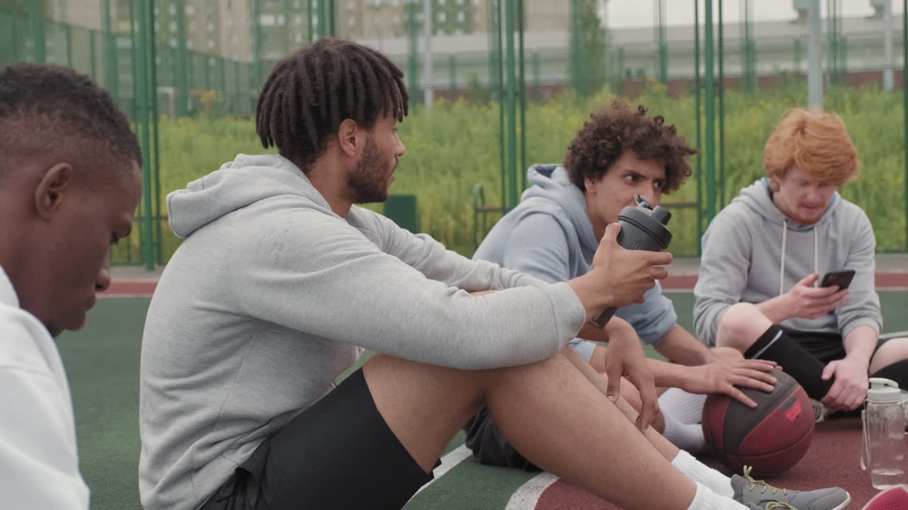 Male Friends Relaxing after Streetball Game