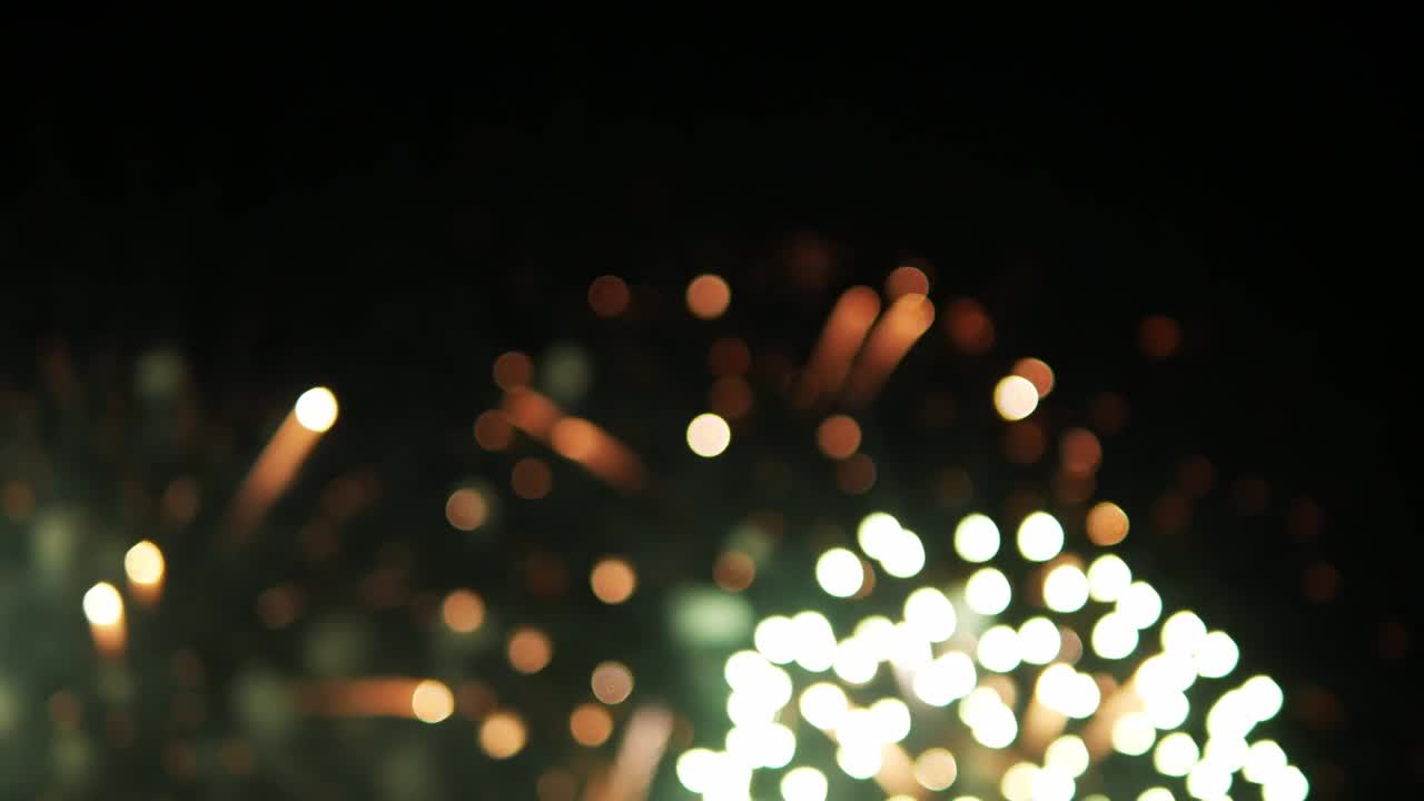 Close-up blurry shot of a fireworks display of a pyrotechnics festival at a beachfront in Southeast Asia
