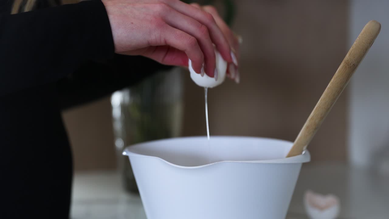 Person Cracking Egg into Bowl while Baking - Close-up, Unrecognizable
