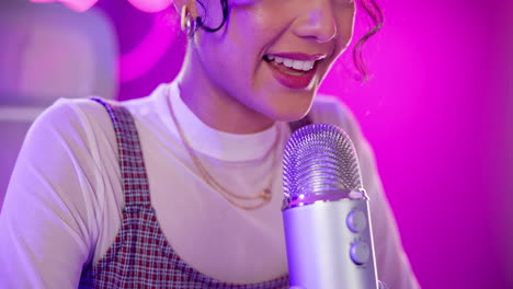 woman recording a podcast with a microphone in a studio