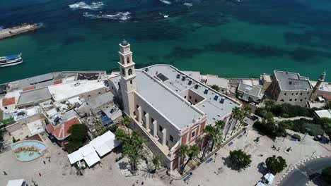 a city with a church, old jaffa, mediterranean sea.