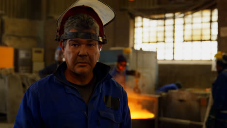 worker standing in protective helmet in foundry workshop 4k