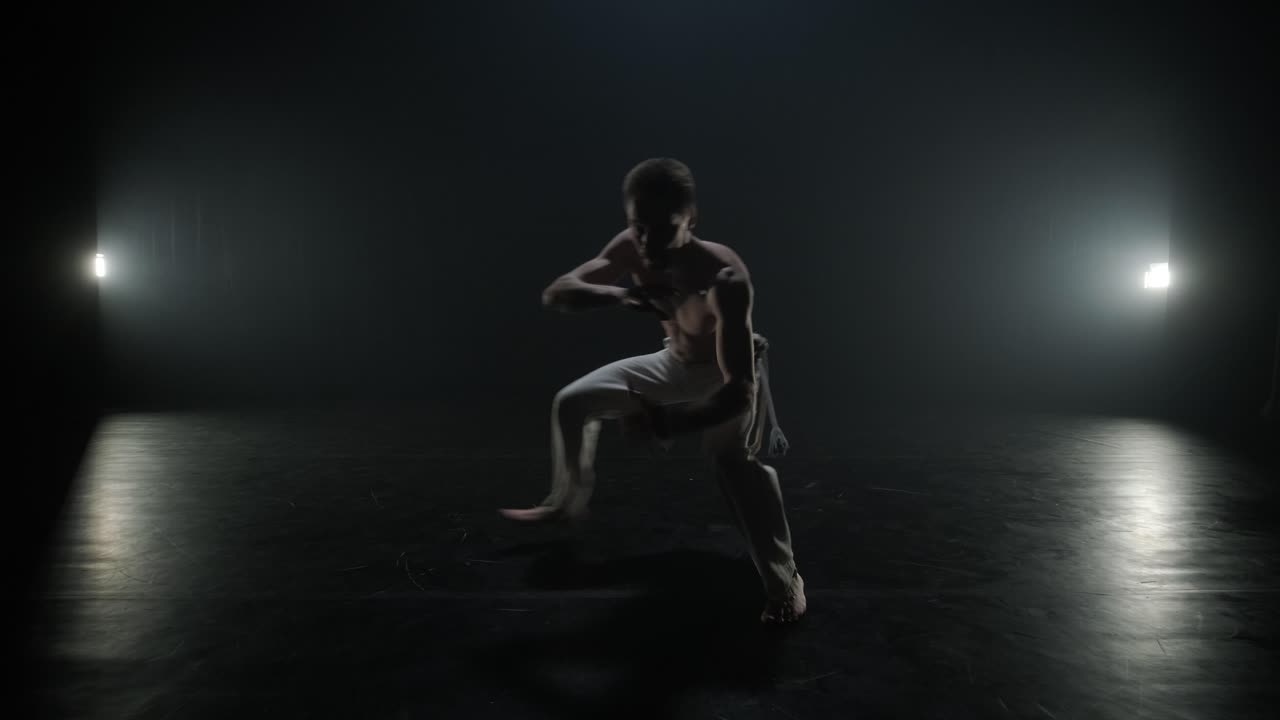 luchadores de capoeira realizando movimientos dinámicos en el escenario. artes marciales, danza y acrobacias en acción. atletas de pecho desnudo mostrando fuerza, flexibilidad y técnica bajo los reflectores
