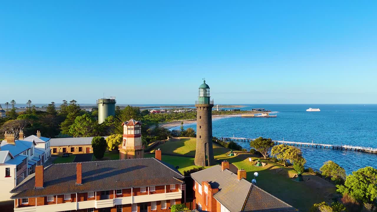 Aerial footage capturing the Queenscliff Lighthouse and surrounding coastline in Bellarine, Victoria, under clear blue skies