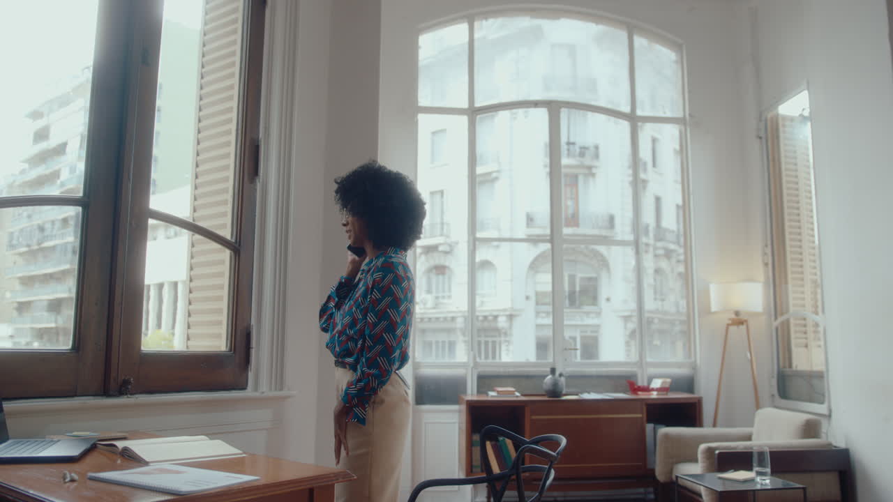 Young Black Businesswoman Talking on Phone in the Office