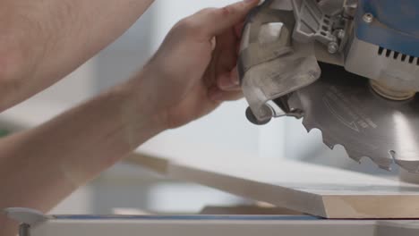 Close-Up-Shot-of-Carpenters-Hands-Lining-Up-Circular-Saw-On-Skirting-Board