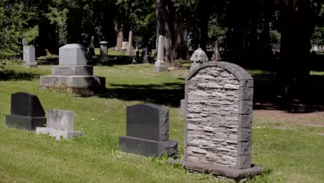 custom unique stone tombstone in grassy graveyard cemetery