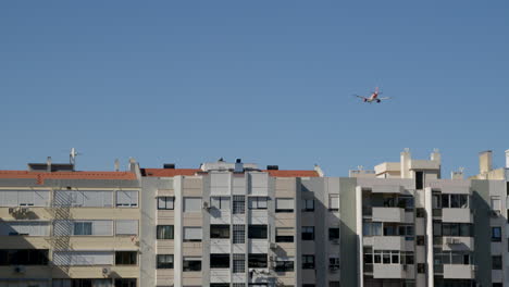 airplane flying over city buildings