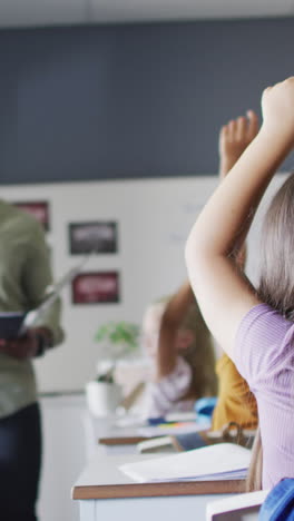 video of happy african american male teacher during lesson with class of diverse pupils