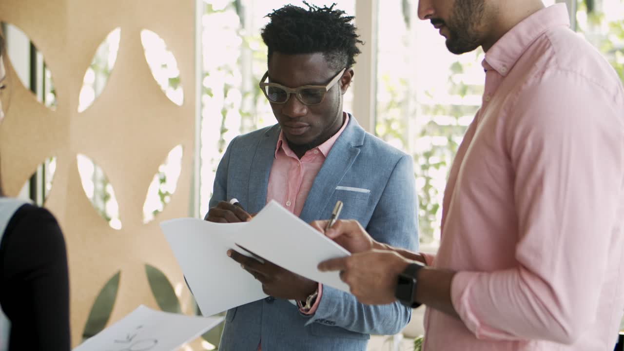 Focused African American employee writing with marker