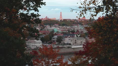 kaunas city aerial with golden autumn trees in the side of the video and christ's resurrection church in the middle of the shot