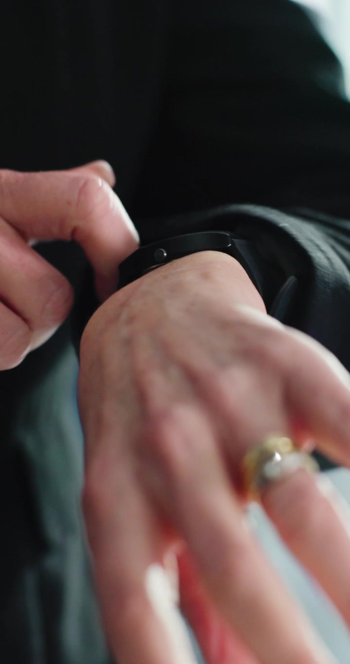 Person Adjusting Smartwatch on Wrist
