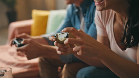 hands video players holding consoles enjoying online game at home close up.