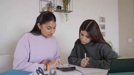 two women studying at a table