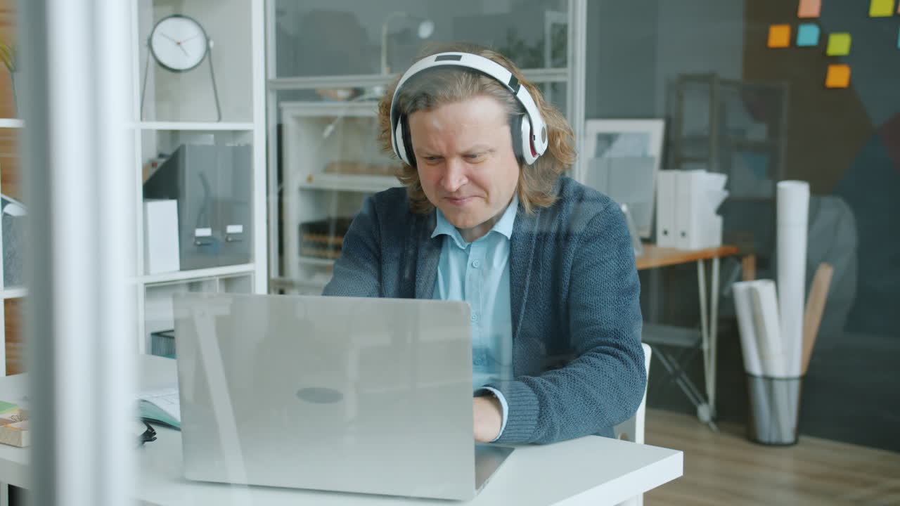 Man working on laptop in a modern office
