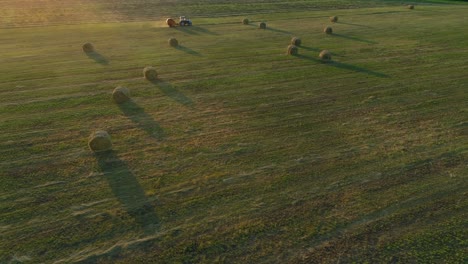 aerial view hay bales at agricultural field in summer at sunset, haystack