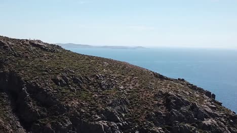 Mykonos-Griechenland-Blaues-Wasser-über-Klippenfelsen