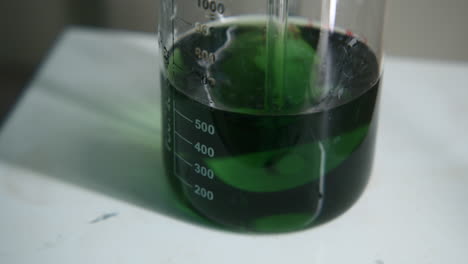 green liquid in beaker