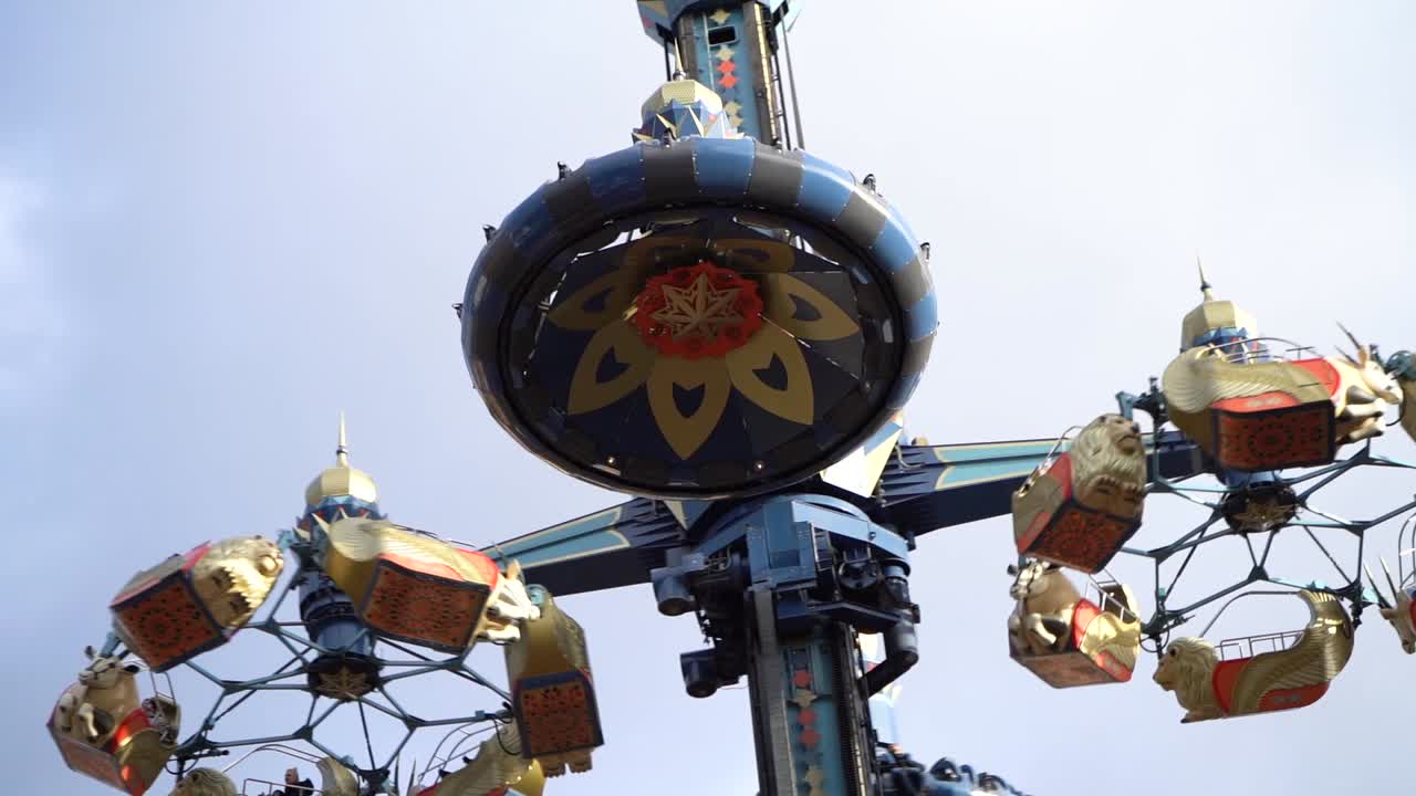 Rotating scenic view on exciting circling amusement ride at Tivoli Gardens, Copenhagen, Denmark, slow motion