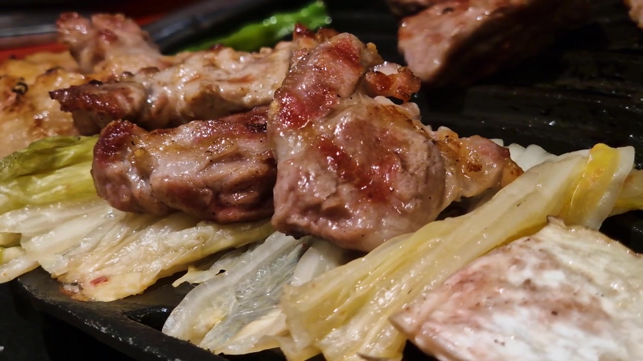Gegrilltes Fleisch auf Kohl, Koreanisches Barbecue im Restaurant, Nahaufnahme